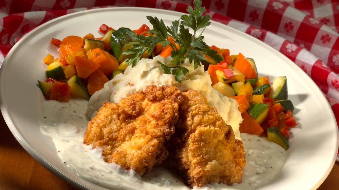 a photo of chicken tenders with veggies on the side