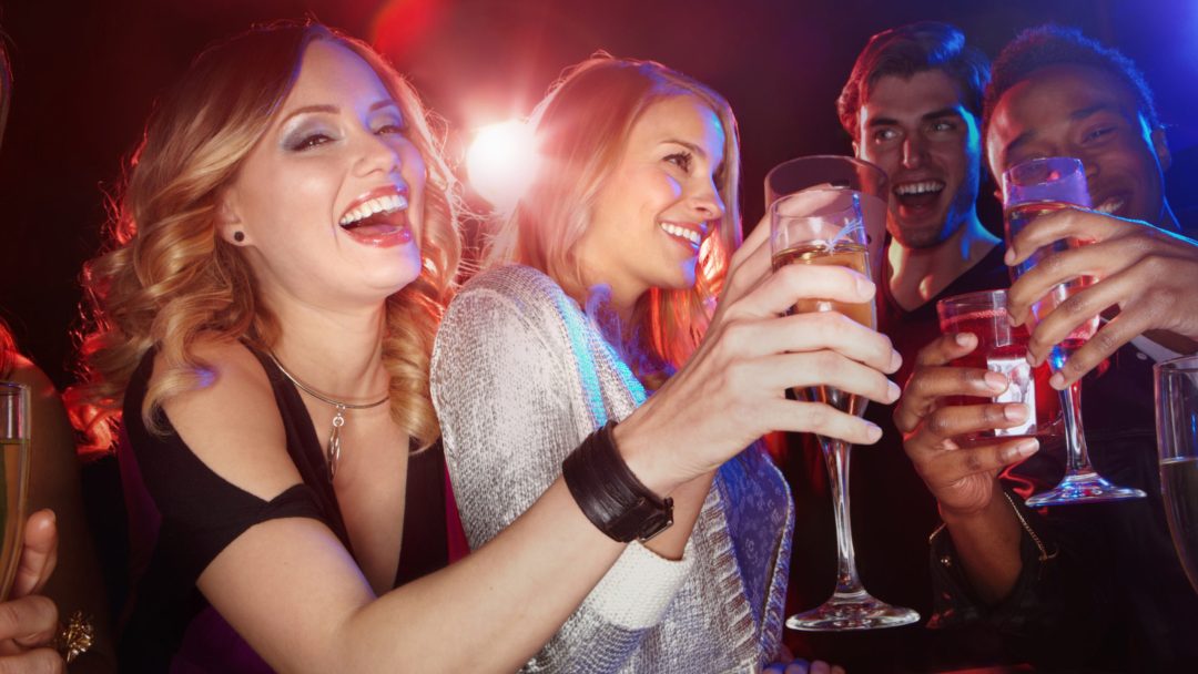 a photo of friends laughing and drinking